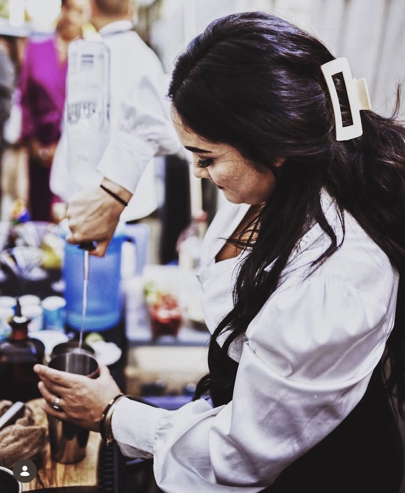 Adina Mercado behind the bar at an event