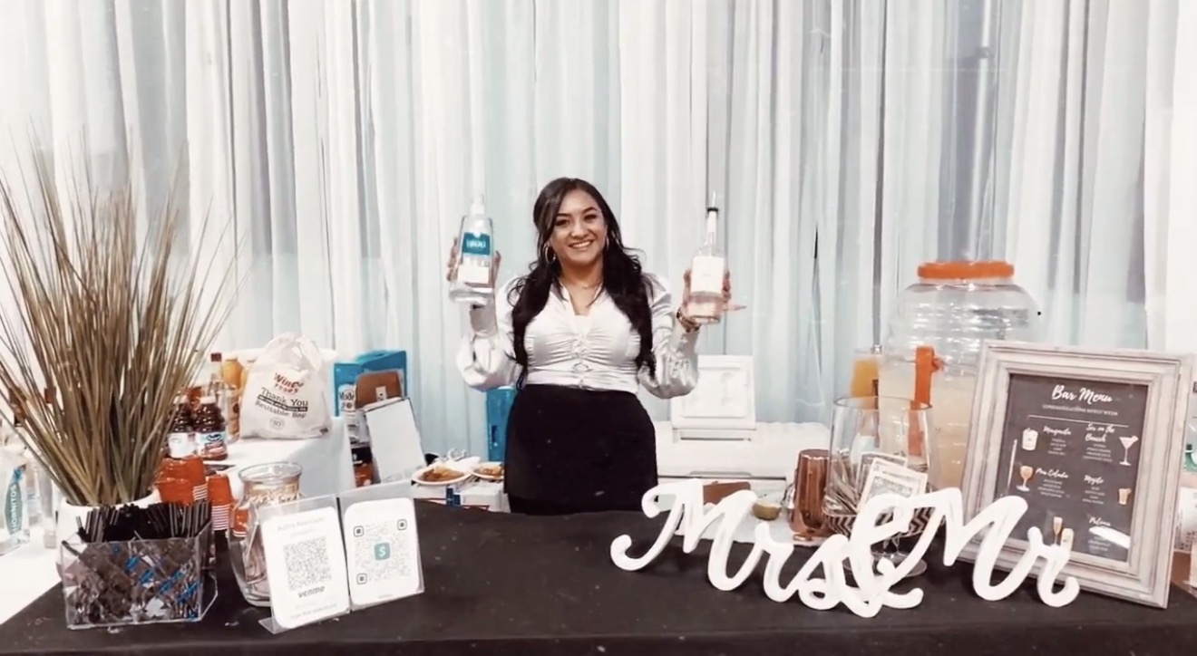 Adina Mercado serving guests at a bartending event